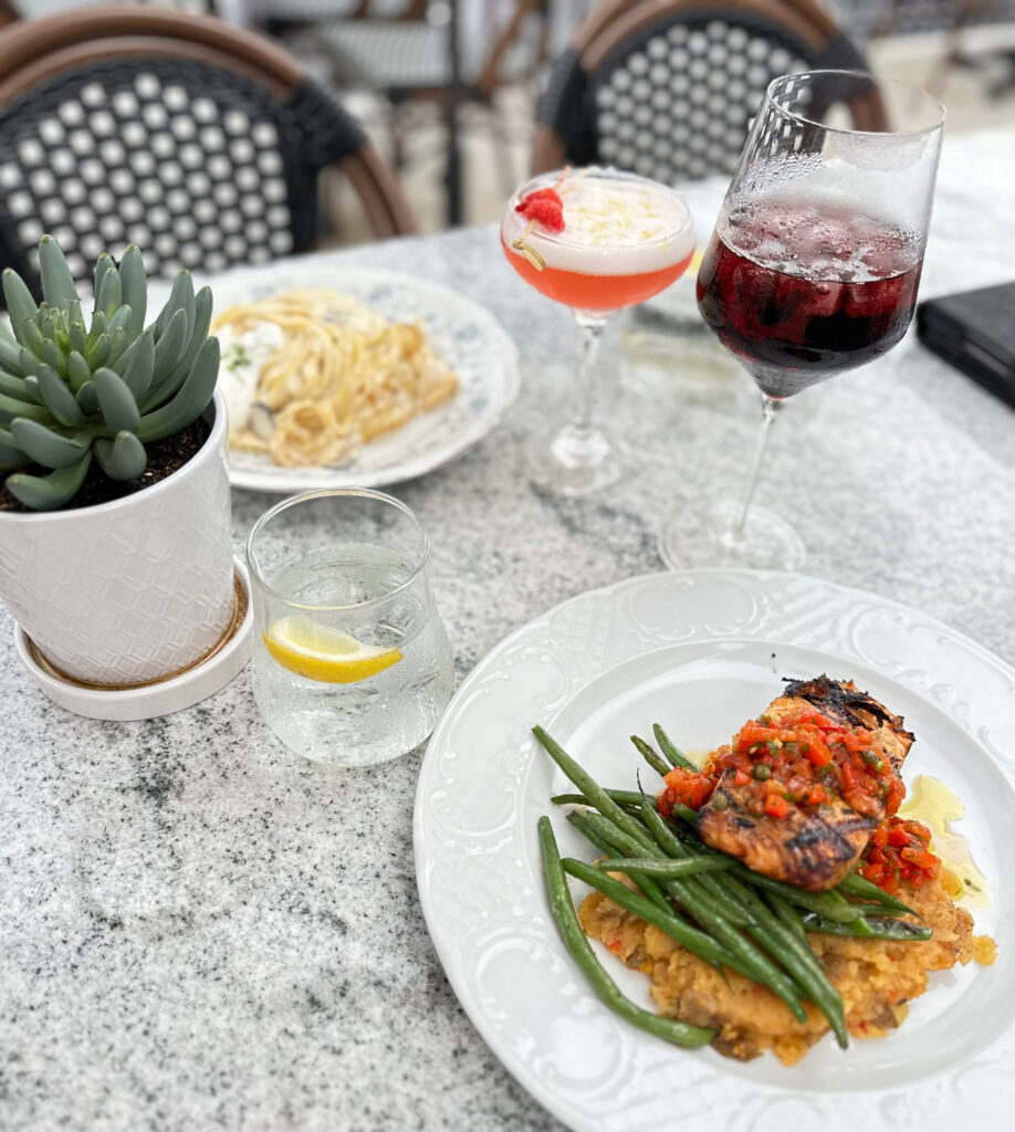 salmon and farro meal on the patio outside at manna uptown in centerville ohio
