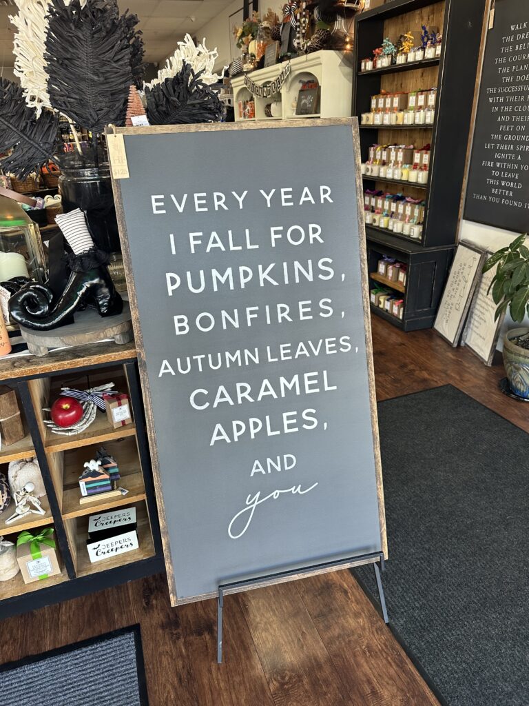 Sign that reads "every year I fall for pumpkins, bonfires, autumn leaves, caramel apples, and you"