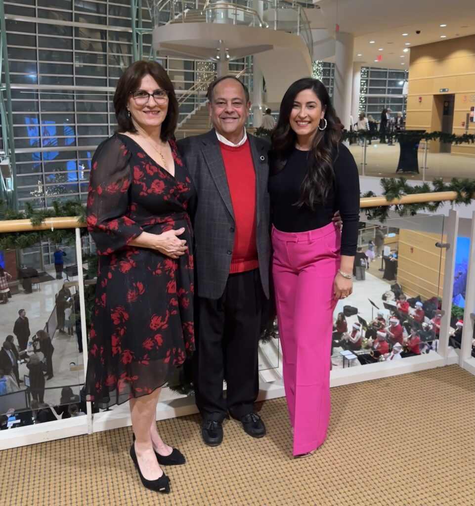 2 women and a man dressed nicely at a convention center to see a show