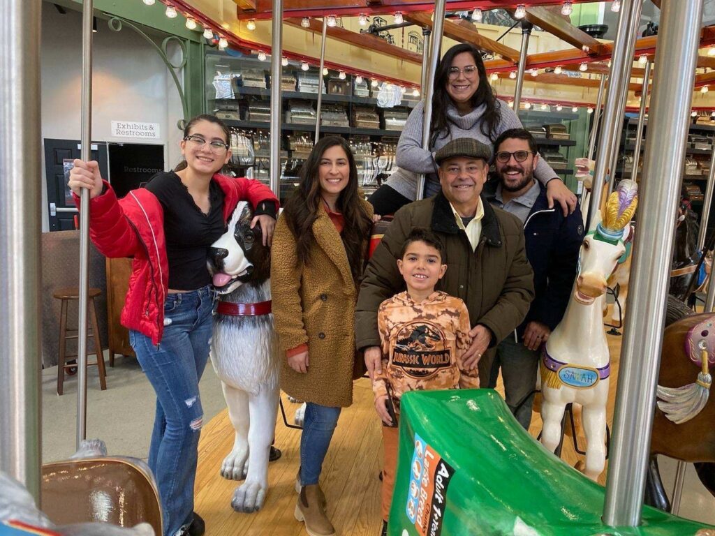 family on an indoor carousel ride