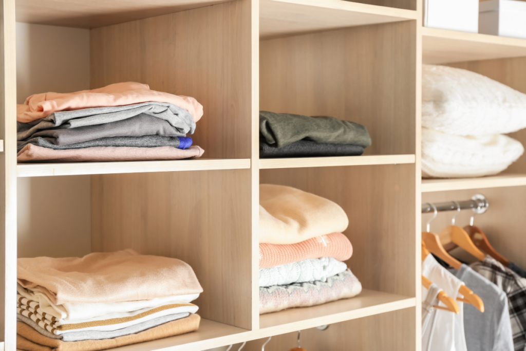 closet organization system with shirts folded inside each cube