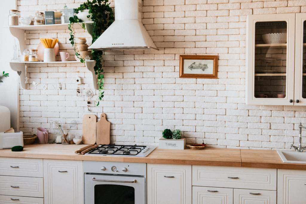 minimalist style kitchen with white brick and white cabinets