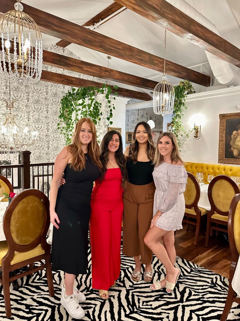 4 women together at a nice restaurant having dinner together