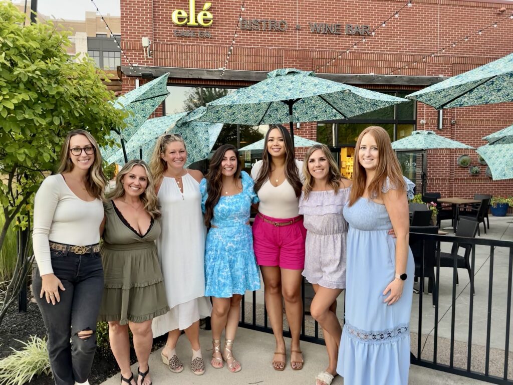 group of girls standing on the patio at ele cake and co 